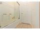 Bathroom shower featuring white tile surround and glass door at 3107 S 74Th Ln, Phoenix, AZ 85043