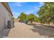 Spacious backyard featuring well-maintained desert landscaping, mature trees, and a neutral color palette at 3461 E Indigo Cir, Mesa, AZ 85213