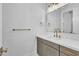 Bathroom with light gray cabinets, white countertop, gold fixtures, and a framed mirror at 3461 E Indigo Cir, Mesa, AZ 85213