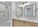 Elegant bathroom featuring double sinks, gold fixtures, and a glass-enclosed shower at 3461 E Indigo Cir, Mesa, AZ 85213
