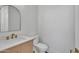Modern powder room features stylish fixtures, sleek toilet, and custom wooden vanity at 3461 E Indigo Cir, Mesa, AZ 85213