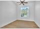 Empty bedroom featuring hard wood floors, a ceiling fan and a window with shutter blinds at 3461 E Indigo Cir, Mesa, AZ 85213