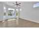 Bright bedroom featuring a bay window with backyard and pool views and wooden floors at 3461 E Indigo Cir, Mesa, AZ 85213