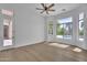Bright bedroom featuring a door to the outside and bay window with backyard and pool views at 3461 E Indigo Cir, Mesa, AZ 85213