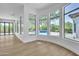 Sunlit bonus room featuring a bay window with backyard and pool views and wooden floors at 3461 E Indigo Cir, Mesa, AZ 85213