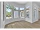 Sunlit bonus room featuring a bay window with outdoor views and wooden floors at 3461 E Indigo Cir, Mesa, AZ 85213