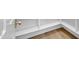Custom closet with white shelves, modern doorknob, and wood flooring at 3461 E Indigo Cir, Mesa, AZ 85213