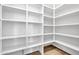 Custom closet with ample shelving and wood flooring, designed for optimal storage and organization at 3461 E Indigo Cir, Mesa, AZ 85213