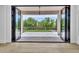 Elegant folding doors open to a backyard, blending indoor and outdoor living seamlessly at 3461 E Indigo Cir, Mesa, AZ 85213