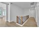 Modern hallway with wood floors and railing that overlooks the expansive interior of the home at 3461 E Indigo Cir, Mesa, AZ 85213