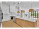 Gourmet kitchen featuring marble counters, stainless appliances, pendant lighting, and custom cabinets at 3461 E Indigo Cir, Mesa, AZ 85213