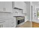 Modern kitchen with stainless steel appliances, white cabinets, stone countertops, and updated fixtures at 3461 E Indigo Cir, Mesa, AZ 85213