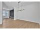 Bright living room with custom shelving, modern lighting, and wood flooring at 3461 E Indigo Cir, Mesa, AZ 85213