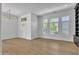 Bright living room featuring hardwood floors, large windows, and contemporary lighting at 3461 E Indigo Cir, Mesa, AZ 85213
