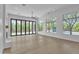 Open living room with floor-to-ceiling glass doors overlooking the pool and landscaping at 3461 E Indigo Cir, Mesa, AZ 85213