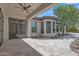 Covered patio showcases travertine tile flooring, recessed lighting, and expansive views of the lush backyard at 3461 E Indigo Cir, Mesa, AZ 85213