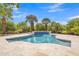 Lush backyard with a sparkling pool, mature trees and stone-paved area creates the perfect outdoor oasis at 3461 E Indigo Cir, Mesa, AZ 85213