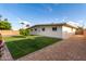 Expansive backyard showcasing a lush lawn and tidy gravel side yard, perfect for outdoor enjoyment and landscaping at 3632 E Poinsettia Dr, Phoenix, AZ 85028