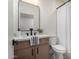Modern bathroom features a wooden vanity, black fixtures and a sleek mirror at 3632 E Poinsettia Dr, Phoenix, AZ 85028