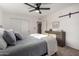 Bedroom features sliding barn door and an upholstered bed with matching gray throw pillows at 3632 E Poinsettia Dr, Phoenix, AZ 85028