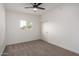 Simple bedroom with carpet, ceiling fan, and a window with natural light at 3632 E Poinsettia Dr, Phoenix, AZ 85028