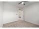 Bedroom with carpet, ceiling fan, and door to another bedroom at 3632 E Poinsettia Dr, Phoenix, AZ 85028