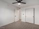 Bright bedroom features plush carpeting, light walls and trim, and closet storage at 3632 E Poinsettia Dr, Phoenix, AZ 85028