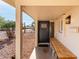 Cozy covered front porch with a wooden bench and charming welcome mat at 3632 E Poinsettia Dr, Phoenix, AZ 85028