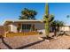 Desert landscaping featuring a mature Saguaro cactus and wooden planters at 3632 E Poinsettia Dr, Phoenix, AZ 85028