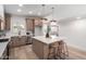 Bright kitchen features a spacious island, modern lighting, stainless steel appliances, and light wood cabinets at 3632 E Poinsettia Dr, Phoenix, AZ 85028