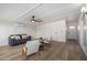 Bright living room with hardwood floors, white walls and a gray couch at 3632 E Poinsettia Dr, Phoenix, AZ 85028