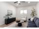 Living room features modern decor, light walls and trim, bright natural light, and neutral toned furnishings at 3632 E Poinsettia Dr, Phoenix, AZ 85028