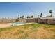 Large backyard with pool surrounded by a chain link fence and mature palms at 3736 W Hazelwood St, Phoenix, AZ 85019