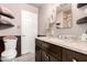 Updated bathroom with dark wood vanity, marble countertops, and wainscoting at 3736 W Hazelwood St, Phoenix, AZ 85019