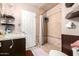 Shower featuring neutral tiles and a marble-look vanity at 3736 W Hazelwood St, Phoenix, AZ 85019