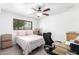 Bedroom area with ceiling fan, work desk and comfortable bed at 3736 W Hazelwood St, Phoenix, AZ 85019