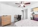 Bedroom showcasing a ceiling fan, work desk, dresser and closet space at 3736 W Hazelwood St, Phoenix, AZ 85019