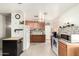 Efficient kitchen with modern appliances and wood-look laminate flooring at 3736 W Hazelwood St, Phoenix, AZ 85019