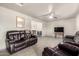 Spacious living room showcasing comfortable seating and a ceiling fan at 3736 W Hazelwood St, Phoenix, AZ 85019