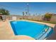 Sparkling in-ground pool surrounded by a concrete patio and secure fencing at 3736 W Hazelwood St, Phoenix, AZ 85019