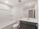 Bathroom with shower over tub, toilet, and single sink vanity with dark cabinets at 4107 S 176Th Dr, Goodyear, AZ 85338