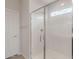 Modern bathroom featuring a glass shower door and white tiled walls at 4107 S 176Th Dr, Goodyear, AZ 85338
