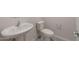 Small bathroom with white pedestal sink, toilet and modern fixtures at 4107 S 176Th Dr, Goodyear, AZ 85338