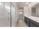Bright bathroom showcasing a walk-in shower and dual sink vanity at 4107 S 176Th Dr, Goodyear, AZ 85338