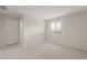 A comfy bedroom with a window and neutral carpet. The door leads to the bathroom at 4107 S 176Th Dr, Goodyear, AZ 85338