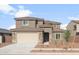 Two-story home with a two-car garage and tile roof, complete with a charming desert landscape at 4107 S 176Th Dr, Goodyear, AZ 85338