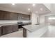 Modern kitchen features granite countertops, stainless appliances, and open layout at 4107 S 176Th Dr, Goodyear, AZ 85338