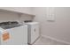 Well-lit laundry room featuring modern washer and dryer appliances at 4107 S 176Th Dr, Goodyear, AZ 85338