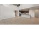 Bright, open living area with soaring ceilings adjacent to a modern kitchen with stainless steel appliances at 4107 S 176Th Dr, Goodyear, AZ 85338
