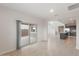 Open living space with tile floors and sliding glass doors, leading to a kitchen with granite countertops at 4107 S 176Th Dr, Goodyear, AZ 85338